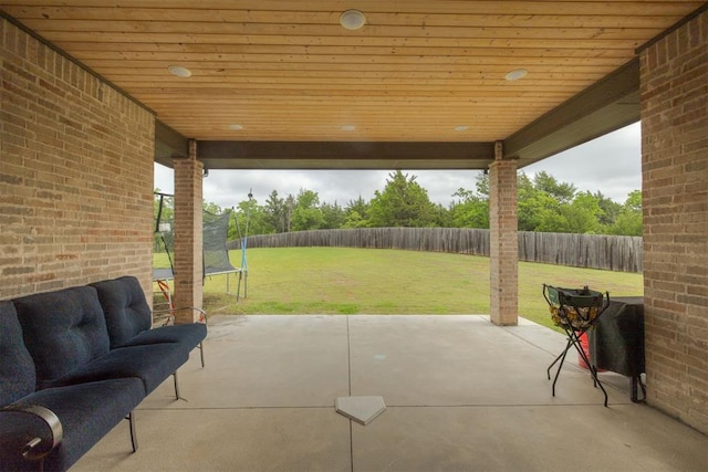 6524 NE 96th Cir, Oklahoma City, OK 73151 - fenced backyard with a trampoline and a patio