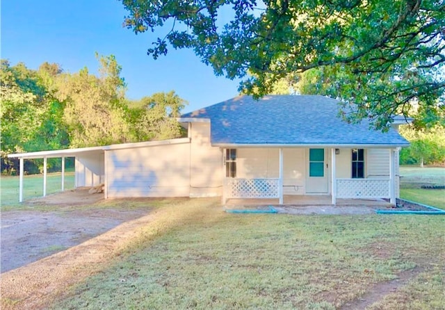 16204 Gaddy Rd, Shawnee, OK 74801 - view of front of home with covered porch, a front lawn, roof with shingles, a carport, and driveway