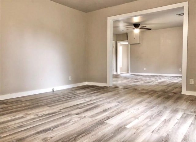 16204 Gaddy Rd, Shawnee, OK 74801 - empty room with wood finished floors, a ceiling fan, and baseboards