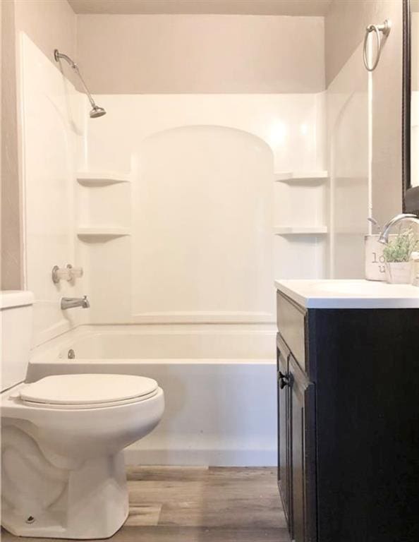 16204 Gaddy Rd, Shawnee, OK 74801 - full bathroom featuring toilet, wood finished floors, washtub / shower combination, and vanity