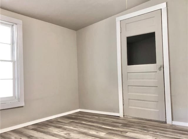 16204 Gaddy Rd, Shawnee, OK 74801 - unfurnished room with baseboards, wood finished floors, and healthy amount of natural light