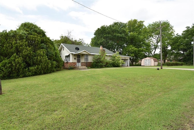220 E Tiger Ave, Wetumka, OK 74883 - ranch-style home with a front lawn, brick siding, a chimney, and a detached garage