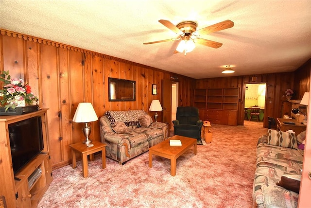 220 E Tiger Ave, Wetumka, OK 74883 - carpeted living room with wood walls, a textured ceiling, and a ceiling fan
