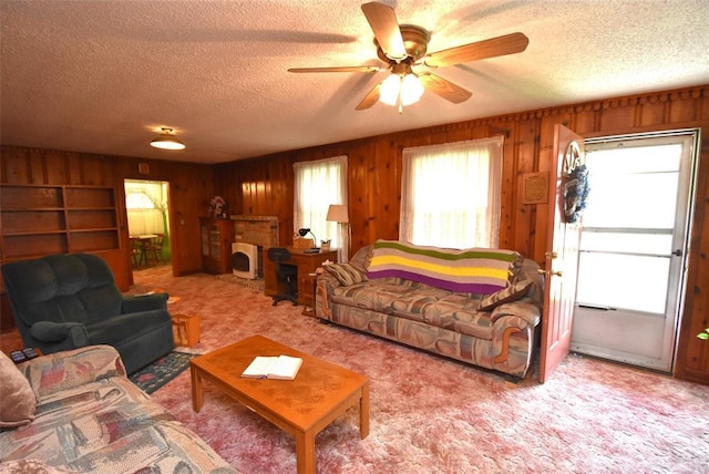 220 E Tiger Ave, Wetumka, OK 74883 - carpeted living room featuring a textured ceiling, ceiling fan, and wood walls