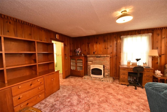 220 E Tiger Ave, Wetumka, OK 74883 - carpeted living room with a textured ceiling, a fireplace, and wooden walls