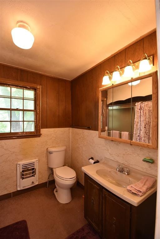 220 E Tiger Ave, Wetumka, OK 74883 - full bath with heating unit, vanity, toilet, and a shower with curtain
