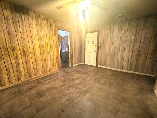 1407 S 9th St, Chickasha, OK 73018 - carpeted empty room with ceiling fan, wooden walls, and baseboards