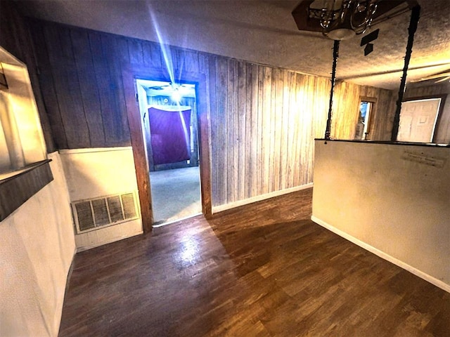 1407 S 9th St, Chickasha, OK 73018 - unfurnished dining area featuring wood walls, wood finished floors, a chandelier, and baseboards