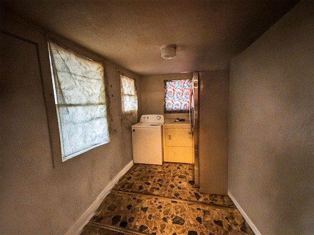 1407 S 9th St, Chickasha, OK 73018 - washroom with separate washer and dryer, baseboards, and dark stone finish floors