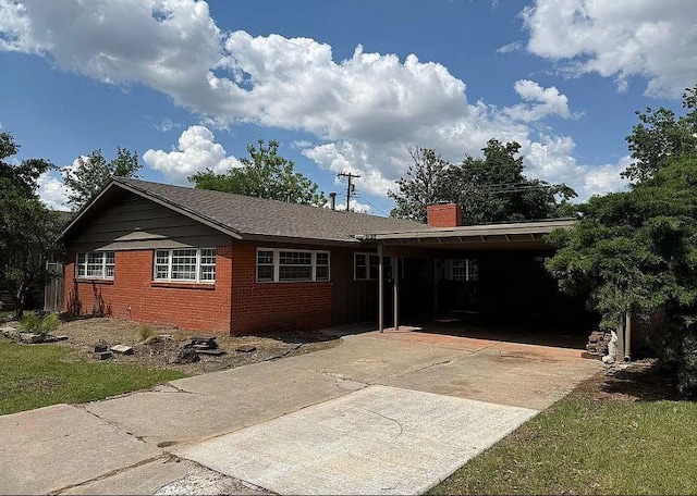 2125 Fremont Dr, The Village, OK 73120 - ranch-style home featuring brick siding, driveway, a chimney, and a carport