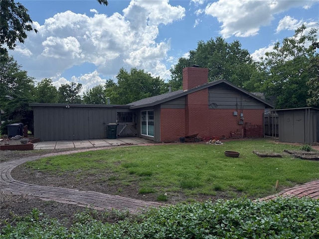 2125 Fremont Dr, The Village, OK 73120 - back of house featuring a chimney, brick siding, and a lawn