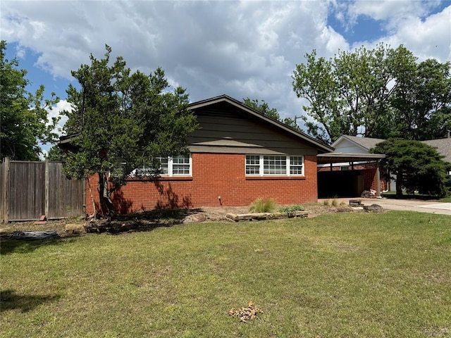 2125 Fremont Dr, The Village, OK 73120 - view of property exterior with concrete driveway, brick siding, and a carport