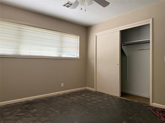 2125 Fremont Dr, The Village, OK 73120 - unfurnished bedroom with a closet, ceiling fan, baseboards, and a textured ceiling