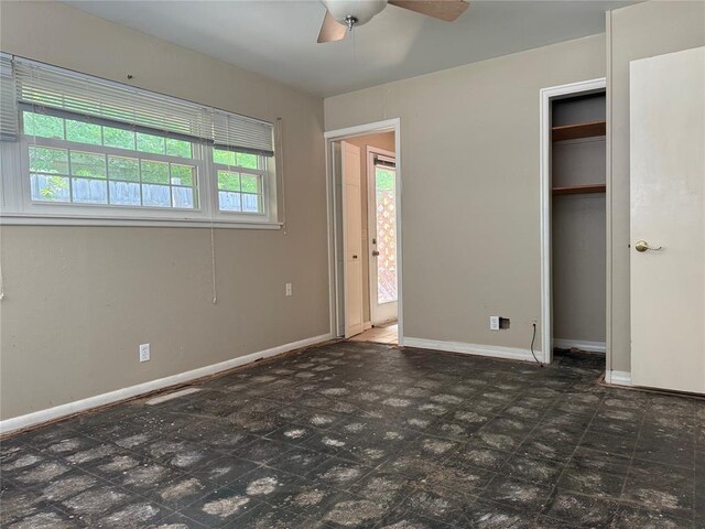 2125 Fremont Dr, The Village, OK 73120 - unfurnished bedroom featuring baseboards, a closet, and ceiling fan