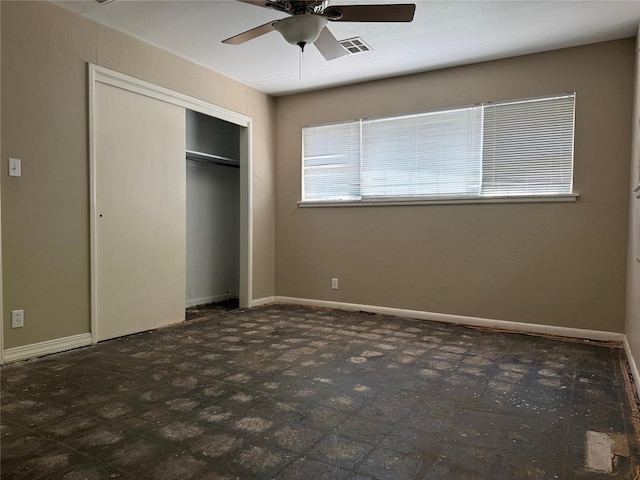 2125 Fremont Dr, The Village, OK 73120 - unfurnished bedroom with a closet, a ceiling fan, and baseboards