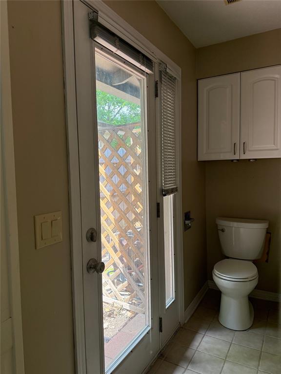 2125 Fremont Dr, The Village, OK 73120 - bathroom featuring toilet, tile patterned floors, and baseboards