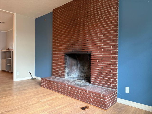 2125 Fremont Dr, The Village, OK 73120 - detailed view of baseboards, wood finished floors, and a fireplace