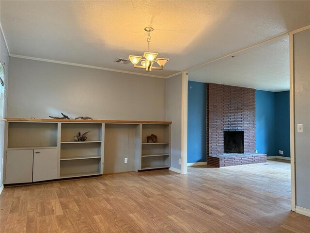 2125 Fremont Dr, The Village, OK 73120 - unfurnished living room featuring a chandelier, light wood finished floors, baseboards, a textured ceiling, and crown molding