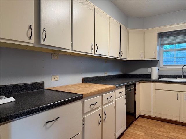 2125 Fremont Dr, The Village, OK 73120 - kitchen with a sink, light wood-style flooring, dishwasher, and dark countertops