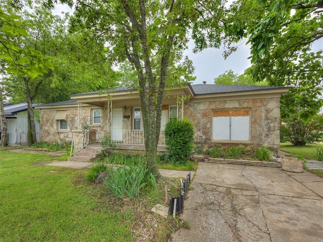 3236 SW 37th St, Oklahoma City, OK 73119 - ranch-style house with stone siding, a front yard, and covered porch