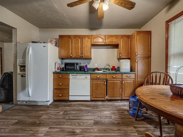 3236 SW 37th St, Oklahoma City, OK 73119 - kitchen featuring white appliances, dark countertops, a ceiling fan, brown cabinets, and dark wood-style floors
