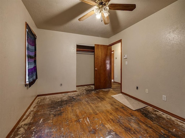 3236 SW 37th St, Oklahoma City, OK 73119 - unfurnished bedroom with wood-type flooring, baseboards, a closet, ceiling fan, and a textured ceiling