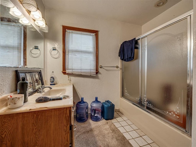 3236 SW 37th St, Oklahoma City, OK 73119 - full bathroom featuring vanity, tile patterned flooring, bath / shower combo with glass door, plenty of natural light, and a textured wall
