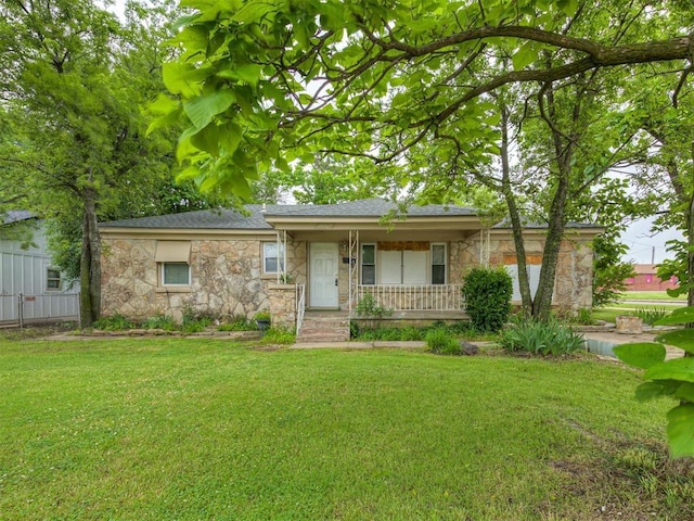 3236 SW 37th St, Oklahoma City, OK 73119 - ranch-style home with stone siding, covered porch, a front yard, and roof with shingles
