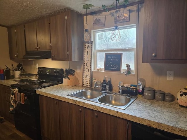 332841 E 890th Rd, Wellston, OK 74881 - kitchen with black appliances, under cabinet range hood, a sink, light countertops, and a textured ceiling