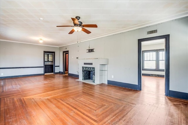 816 W Padon St, Blackwell, OK 74631 - unfurnished living room featuring ceiling fan, a fireplace with flush hearth, baseboards, and ornamental molding