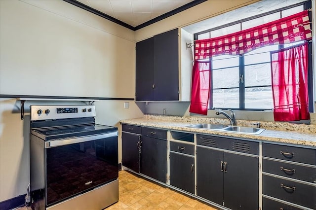 816 W Padon St, Blackwell, OK 74631 - kitchen with stainless steel range with electric cooktop, a sink, ornamental molding, and dark cabinets