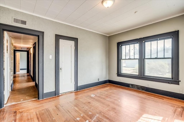 816 W Padon St, Blackwell, OK 74631 - unfurnished room featuring crown molding, hardwood / wood-style floors, and a textured wall