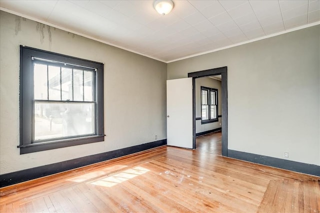 816 W Padon St, Blackwell, OK 74631 - unfurnished room featuring hardwood / wood-style floors, ornamental molding, and baseboards