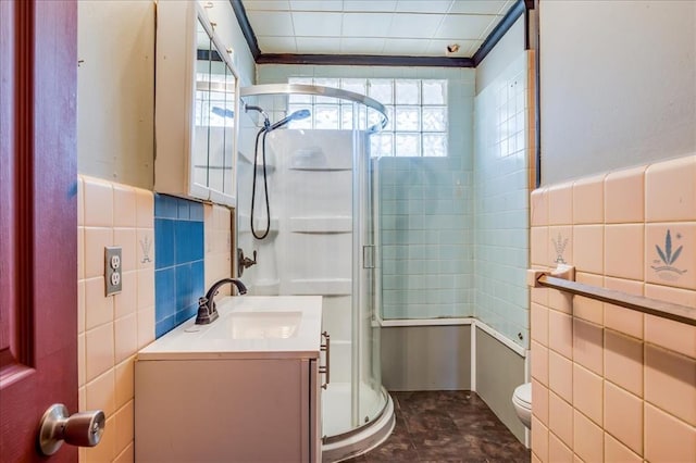 816 W Padon St, Blackwell, OK 74631 - full bathroom with tile walls, toilet, healthy amount of natural light, a stall shower, and vanity