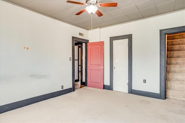 816 W Padon St, Blackwell, OK 74631 - unfurnished bedroom with carpet, baseboards, and ceiling fan