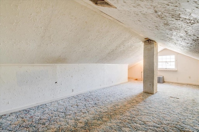816 W Padon St, Blackwell, OK 74631 - bonus room with carpet flooring, a textured wall, a textured ceiling, lofted ceiling, and baseboards