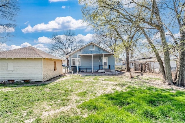816 W Padon St, Blackwell, OK 74631 - back of house featuring a lawn and brick siding