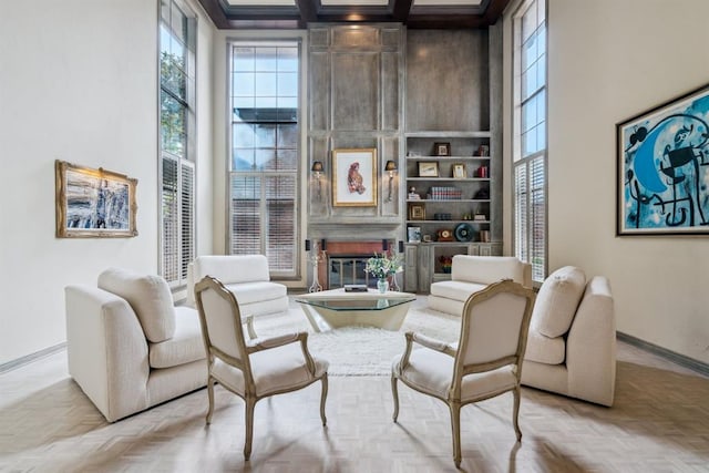 6206 Waterford Blvd Unit 78, Oklahoma City, OK 73118 - living room featuring a high ceiling, baseboards, a glass covered fireplace, coffered ceiling, and beam ceiling