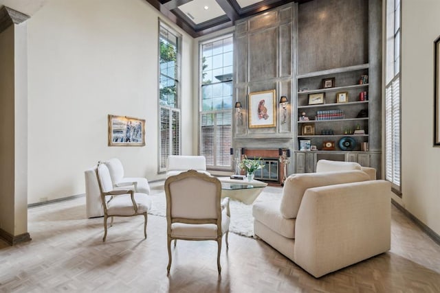 6206 Waterford Blvd Unit 78, Oklahoma City, OK 73118 - living area with a large fireplace, a high ceiling, baseboards, beam ceiling, and coffered ceiling