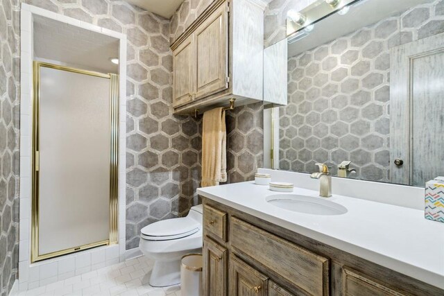 6206 Waterford Blvd Unit 78, Oklahoma City, OK 73118 - full bathroom featuring vanity, tile patterned flooring, a stall shower, and toilet