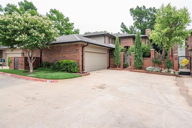 6206 Waterford Blvd Unit 78, Oklahoma City, OK 73118 - view of front facade featuring brick siding, an attached garage, driveway, a chimney, and a gate