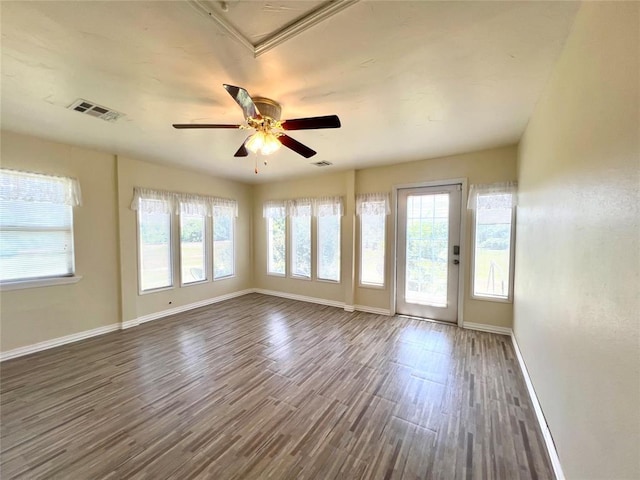 416 E Quail Rd, Chickasha, OK 73018 - unfurnished room featuring baseboards, dark wood-style flooring, and ceiling fan