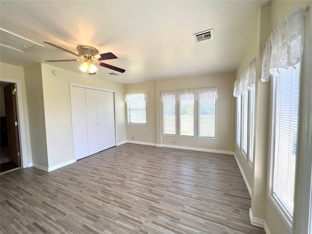 416 E Quail Rd, Chickasha, OK 73018 - unfurnished bedroom featuring baseboards, wood finished floors, a closet, and ceiling fan