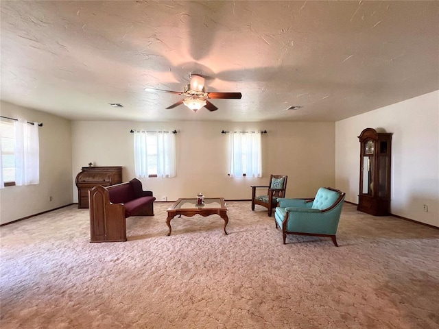 416 E Quail Rd, Chickasha, OK 73018 - living area with light colored carpet, a ceiling fan, and baseboards