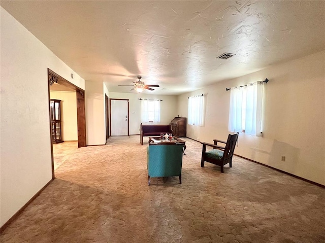 416 E Quail Rd, Chickasha, OK 73018 - living area featuring light colored carpet, baseboards, and ceiling fan