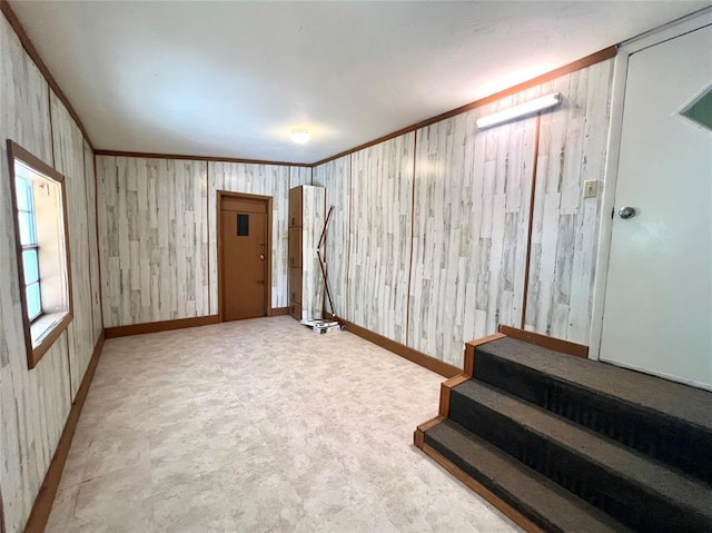 416 E Quail Rd, Chickasha, OK 73018 - spare room featuring baseboards, crown molding, and stairway