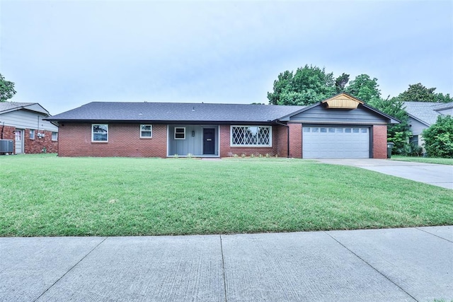336 N Sherry Ave, Norman, OK 73069 - ranch-style house with a garage, concrete driveway, a front yard, and brick siding