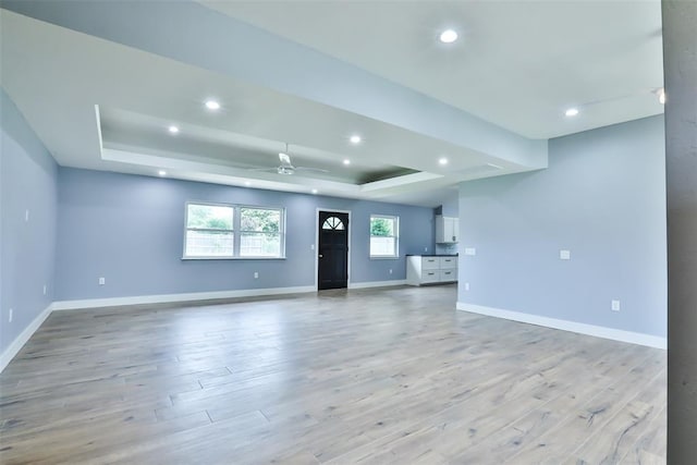 336 N Sherry Ave, Norman, OK 73069 - unfurnished living room with a raised ceiling, recessed lighting, light wood finished floors, and a ceiling fan