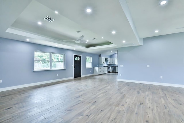 336 N Sherry Ave, Norman, OK 73069 - unfurnished living room featuring a raised ceiling, light wood-style floors, recessed lighting, and ceiling fan