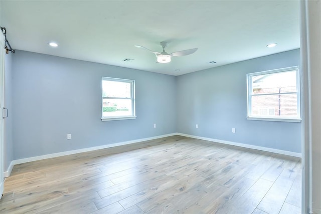 336 N Sherry Ave, Norman, OK 73069 - unfurnished room featuring a ceiling fan, light wood finished floors, recessed lighting, and a barn door